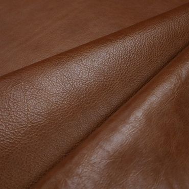 Close-up of textured brown leather fabric.