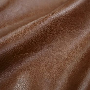 Close-up of textured brown leather material with natural creases.