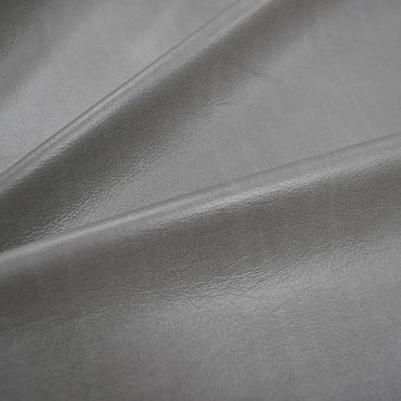 Close-up of smooth gray leather fabric.