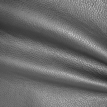 Close-up of textured black leather fabric folds.