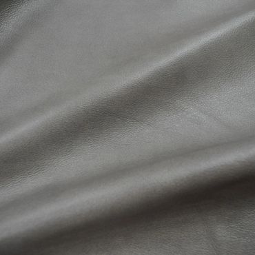 Close-up of smooth gray leather texture with subtle grain.
