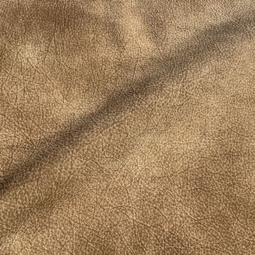 Close-up of textured brown leather surface with natural creases and grain.