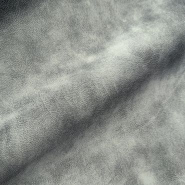 Close-up of textured gray leather fabric with natural creases.