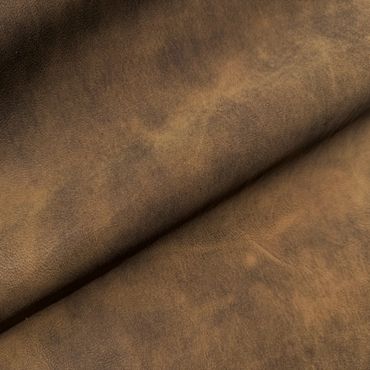 Close-up of textured brown leather fabric with natural creases.