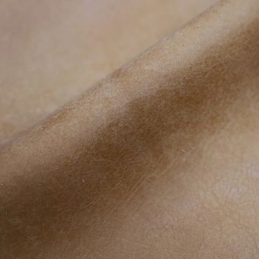 Close-up of brown suede fabric showing its texture and softness.