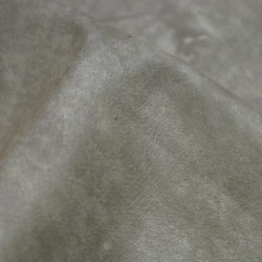 Close-up of a soft, textured gray fabric with subtle folds.