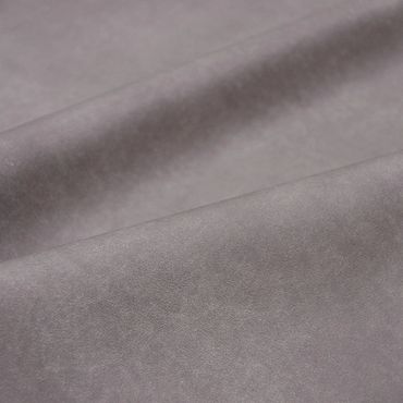 Close-up of soft, gray suede fabric with gentle folds.