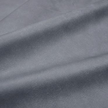 Close-up of smooth gray fabric with subtle texture and folds.