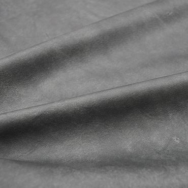 Close-up of smooth grey leather fabric with natural texture.