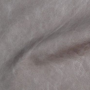 Close-up of gray leather texture with natural wrinkles and grain.