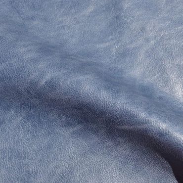 Close-up of textured blue leather material with subtle wrinkles.