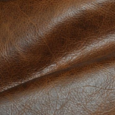 Close-up of textured brown leather fabric with natural creases.