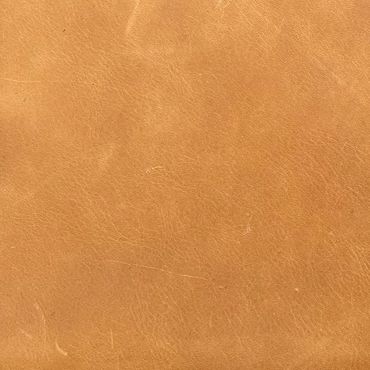 Close-up of smooth, tan leather texture with natural grain patterns.