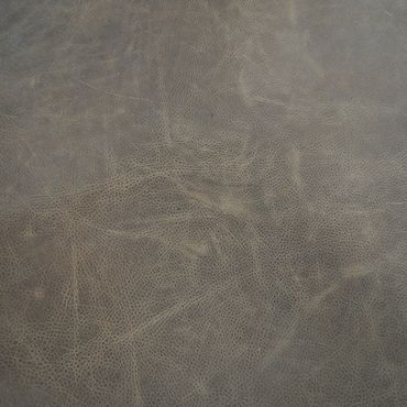 Close-up of textured brown leather surface with natural creases.