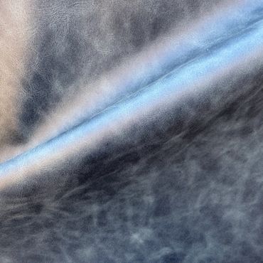 Close-up of textured blue and beige leather material.