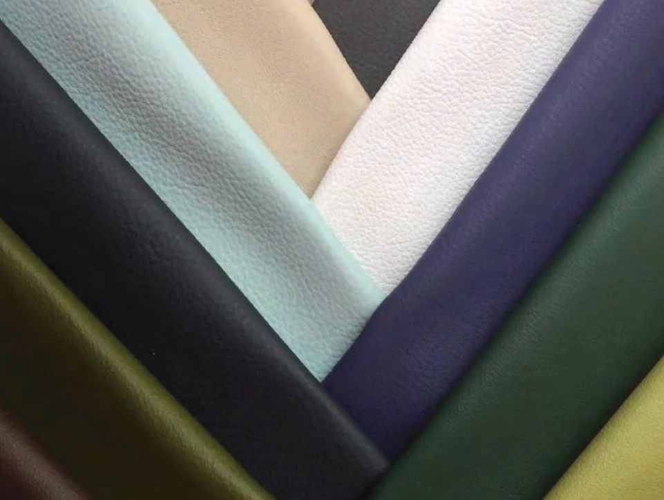 Various colored leather fabric samples arranged in a fan shape.