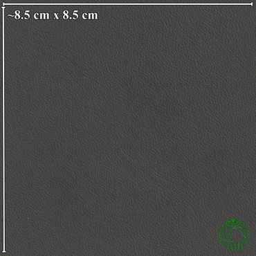 Close-up of dark gray leather texture with fine grain patterns and measurement scale.