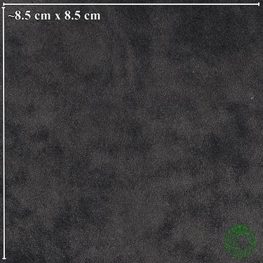 Close-up of a black textured surface with a size reference of 8.5 cm by 8.5 cm.