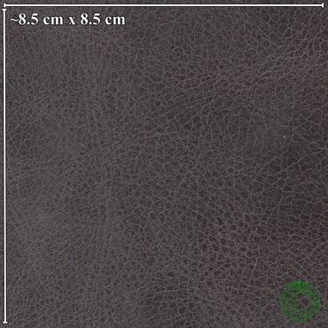 Close-up of black leather texture with measurement scale of 8.5 cm by 8.5 cm.