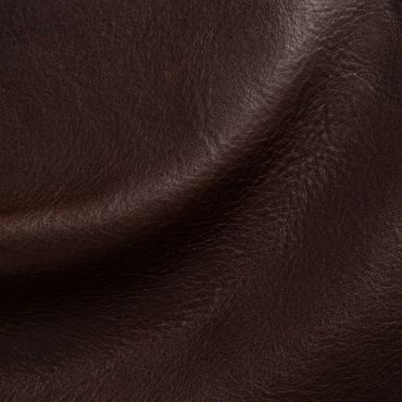 Close-up of textured dark brown leather fabric.