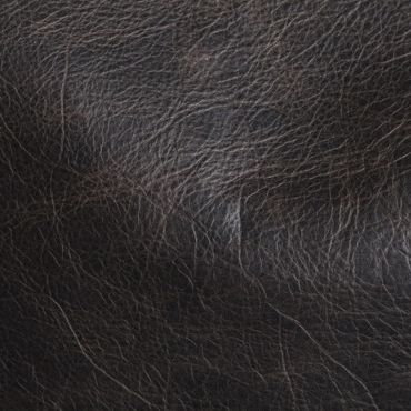 Close-up of dark brown textured leather surface.