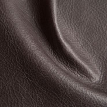 Close-up of textured dark brown leather fabric with natural creases.