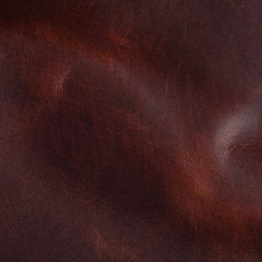 Close-up of rich brown leather texture with natural creases.
