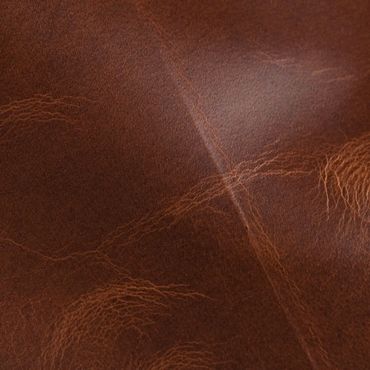 Close-up of brown leather texture with natural creases and grain.