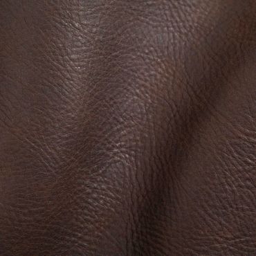 Close-up of textured dark brown leather material.