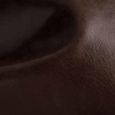 Close-up of textured dark brown leather surface.