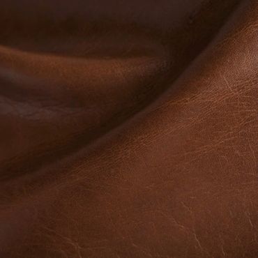 Close-up of brown leather texture with natural creases and grain.