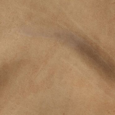 Close-up of soft, tan-colored suede fabric with visible texture and folds.