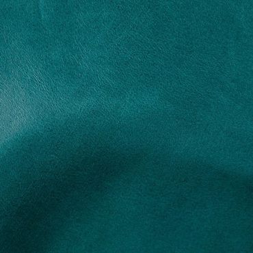 Close-up of textured teal leather fabric.