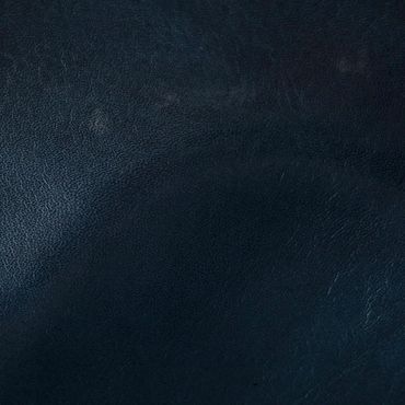 Close-up of dark blue textured leather surface.