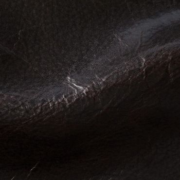 Close-up of textured black leather surface with natural creases.