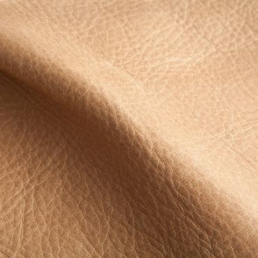 Close-up of textured tan leather surface with natural creases.