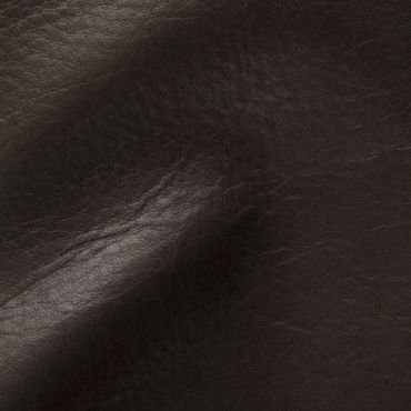 Close-up of dark brown leather texture with natural wrinkles and shine.