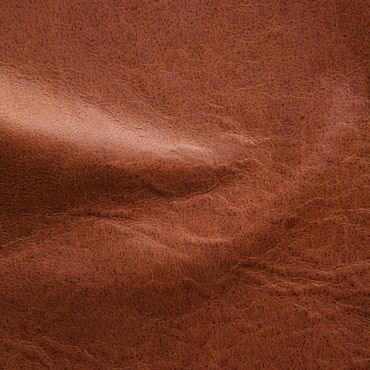 Close-up of textured brown leather surface with natural creases.