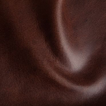 Close-up of smooth, dark brown leather texture with subtle wrinkles and shine.