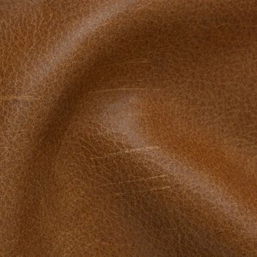 Close-up of textured brown leather surface with natural creases.