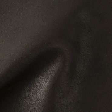 Close-up of black leather texture with natural folds and grain.
