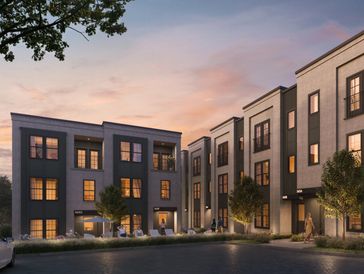 Modern apartment complex at sunset with warm interior lighting.