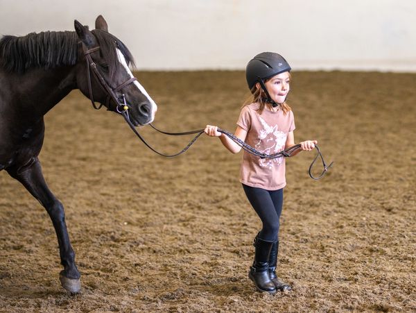 girl leading a pony