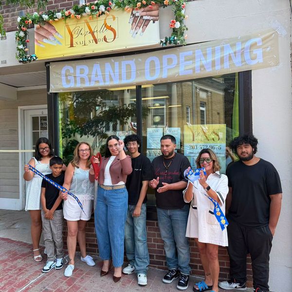 Group posing at nail studio grand opening.