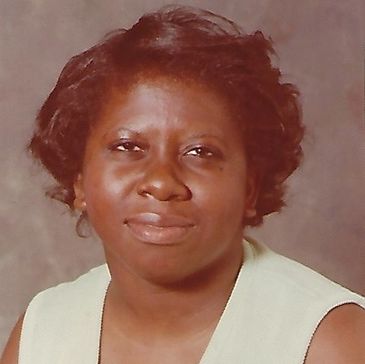 Portrait of a woman with short hair and a calm expression.