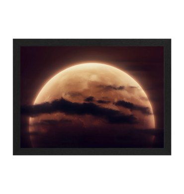 A glowing moon partially obscured by dark clouds at night.