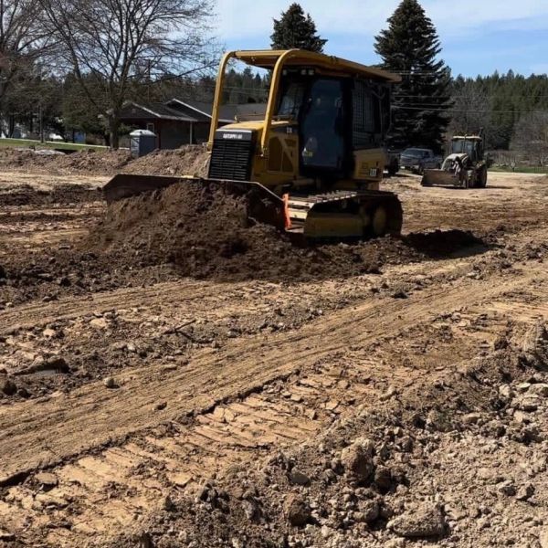 Bulldozer pushing dirt at construction site.