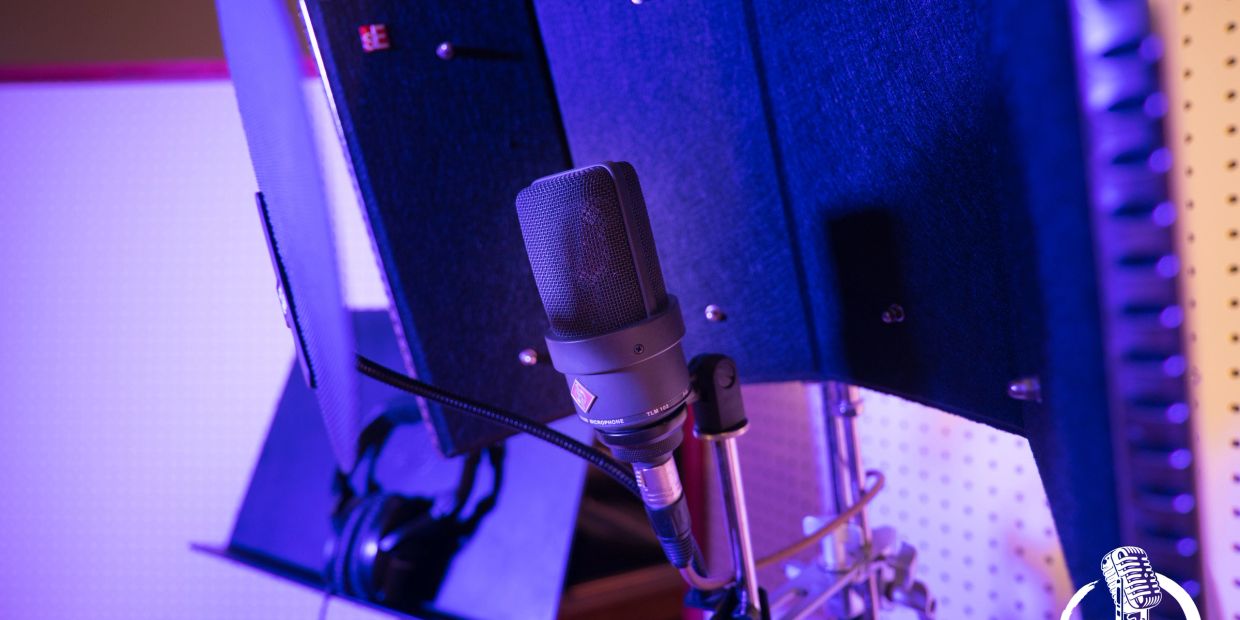 Professional microphone setup in a softly lit recording studio.