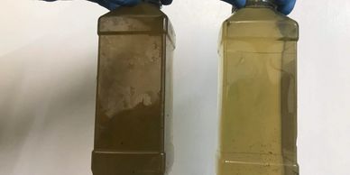 Sample water bottles showing clean and dirty river water