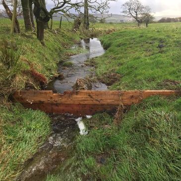 Leaky dams in a watercourse help to slow the flow of water